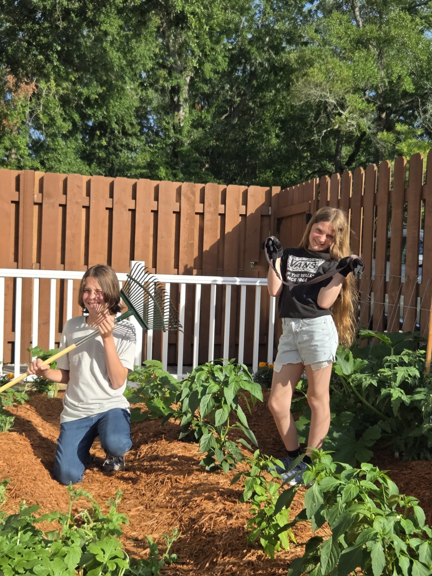 The Avondale Helpers kids doing yard work in a garden